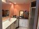Bathroom featuring sink, vanity, mirror, shower stall, and peach colored walls at 5855 La Costa Dr # S, Orlando, FL 32807