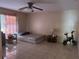 Bedroom view with tiled flooring, ceiling fan, bed and side tables at 5855 La Costa Dr # S, Orlando, FL 32807