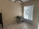 Bedroom view featuring tile flooring, ceiling fan, window, desk and chair at 5855 La Costa Dr # S, Orlando, FL 32807