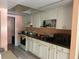 Kitchen view with white cabinetry, dark countertops, sink, and appliances at 5855 La Costa Dr # S, Orlando, FL 32807