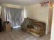 View of the living room, featuring tile flooring, a window and a couch at 5855 La Costa Dr # S, Orlando, FL 32807