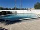 Community pool surrounded by a white fence and some landscaping at 5855 La Costa Dr # S, Orlando, FL 32807