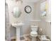 Cozy bathroom featuring a pedestal sink, a toilet, and classic fixtures at 6013 Thames Way, Orlando, FL 32807
