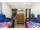 Shared bedroom with two wooden beds, closet and a dresser at 6013 Thames Way, Orlando, FL 32807