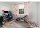 Bedroom featuring a desk, chair, and an exercise bench at 6013 Thames Way, Orlando, FL 32807