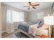 Bright bedroom with a ceiling fan, natural light, and stylish wood-look floors at 6013 Thames Way, Orlando, FL 32807