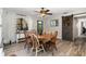 Sunlit dining room featuring a round table, six chairs, and a sliding barn door at 6013 Thames Way, Orlando, FL 32807