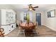 Bright dining room with a vintage cabinet, round table, and six chairs at 6013 Thames Way, Orlando, FL 32807