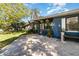 Inviting front porch featuring decorative hanging baskets, plants, and an American flag display at 6013 Thames Way, Orlando, FL 32807