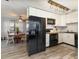 Charming kitchen with stainless steel appliances, white cabinets, and modern lighting at 6013 Thames Way, Orlando, FL 32807