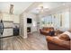 Open-concept living area with kitchen access, fireplace, and bright windows at 6013 Thames Way, Orlando, FL 32807