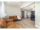 Inviting living room with hardwood floors, comfortable leather sofa, and a sliding barn door at 6013 Thames Way, Orlando, FL 32807