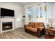Living area features bright windows, fireplace, and wood-look floors at 6013 Thames Way, Orlando, FL 32807