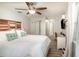 Bright main bedroom with an ensuite bathroom and a wooden accent headboard at 6013 Thames Way, Orlando, FL 32807
