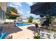 Inviting backyard pool area with sunshade sail, outdoor seating, and a well-maintained yard at 6013 Thames Way, Orlando, FL 32807