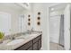 Modern bathroom featuring double sinks, granite countertops and a shower/tub combo at 6049 Broad Oak Dr, Davenport, FL 33837
