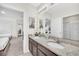Bathroom offers double granite vanity, a large mirror, and access to the bedroom at 6049 Broad Oak Dr, Davenport, FL 33837
