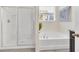 Bright bathroom featuring a tub, glass shower, and granite countertop vanity at 6049 Broad Oak Dr, Davenport, FL 33837