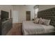 Stylish bedroom with a large tufted headboard bed, dresser, and bedside tables at 6049 Broad Oak Dr, Davenport, FL 33837