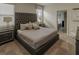 Sophisticated bedroom showcasing a tufted headboard bed and a modern nightstand at 6049 Broad Oak Dr, Davenport, FL 33837
