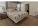 Spacious primary bedroom with neutral tones, complete with lamps and an adjacent bathroom at 6049 Broad Oak Dr, Davenport, FL 33837