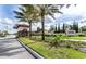 Scenic view of the Solterra Resort entrance with a guardhouse, lush greenery, and a glimpse of the community sign at 6049 Broad Oak Dr, Davenport, FL 33837