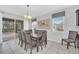 Bright dining room featuring a modern chandelier, large windows, and sliding glass door leading to the pool area at 6049 Broad Oak Dr, Davenport, FL 33837