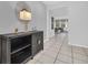 Bright foyer with tiled floors, a decorative console table, and a view into the open living area at 6049 Broad Oak Dr, Davenport, FL 33837