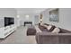 Carpeted game room with a sectional sofa, ottoman, foosball table, and a wall-mounted TV at 6049 Broad Oak Dr, Davenport, FL 33837