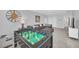 Spacious game room featuring a foosball table, a sectional sofa, and neutral carpet at 6049 Broad Oak Dr, Davenport, FL 33837