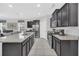 Modern kitchen with stainless steel appliances, granite countertops, dark wood cabinets, and tile flooring at 6049 Broad Oak Dr, Davenport, FL 33837