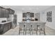 Kitchen with stainless steel refrigerator, dark cabinets, granite countertops, and a large island with seating at 6049 Broad Oak Dr, Davenport, FL 33837
