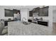 Close up shot of the kitchen island with stainless steel appliances and white granite countertops at 6049 Broad Oak Dr, Davenport, FL 33837