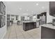 Spacious kitchen featuring a center island, granite countertops, stainless steel appliances, and an open living area at 6049 Broad Oak Dr, Davenport, FL 33837