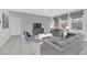 Cozy living room with comfortable seating, a large television, and neutral décor at 6049 Broad Oak Dr, Davenport, FL 33837
