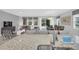 Open living and dining area with modern decor, lots of natural light and access to the pool at 6049 Broad Oak Dr, Davenport, FL 33837