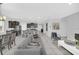 Open concept living room and kitchen with island barstool seating, modern furniture, and lots of light at 6049 Broad Oak Dr, Davenport, FL 33837