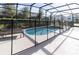 Sparkling pool and spa enclosed by screen with safety fence for peace of mind at 6049 Broad Oak Dr, Davenport, FL 33837