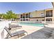 A serene community pool with lounge chairs, surrounded by a white picket fence at 698 Seabrook Ct # 103, Altamonte Springs, FL 32714
