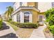 Inviting townhouse featuring a white front door, arched windows, and meticulously maintained landscaping at 698 Seabrook Ct # 103, Altamonte Springs, FL 32714