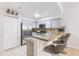 Well-equipped kitchen with stainless steel appliances, gray cabinetry and breakfast bar seating at 698 Seabrook Ct # 103, Altamonte Springs, FL 32714