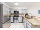 Modern kitchen with stainless steel appliances, granite countertops, and ample cabinet space at 698 Seabrook Ct # 103, Altamonte Springs, FL 32714