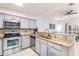 Bright kitchen featuring stainless steel appliances, granite countertops, and breakfast bar seating at 698 Seabrook Ct # 103, Altamonte Springs, FL 32714