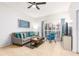 Inviting living room featuring a gray sofa, blue accents, and sliding doors providing natural light at 698 Seabrook Ct # 103, Altamonte Springs, FL 32714