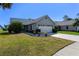 Charming home with a well-kept front yard, beautiful landscaping, and an inviting curb appeal at 704 Sky Tree Ct, New Smyrna Beach, FL 32168