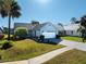 Charming single-story home with a well-manicured lawn, mature landscaping and inviting curb appeal at 704 Sky Tree Ct, New Smyrna Beach, FL 32168