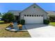 Charming residence features a well-maintained front yard with decorative flower pots and a lovely garden at 704 Sky Tree Ct, New Smyrna Beach, FL 32168