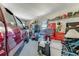 Spacious garage with ample storage, featuring tool chests, shelving, and a parked vehicle for convenient access and organization at 704 Sky Tree Ct, New Smyrna Beach, FL 32168