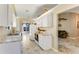 Well-lit kitchen featuring white cabinets, stainless appliances, tile floors, and neutral walls at 704 Sky Tree Ct, New Smyrna Beach, FL 32168