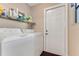 Laundry room with modern appliances and shelving for storage at 704 Sky Tree Ct, New Smyrna Beach, FL 32168